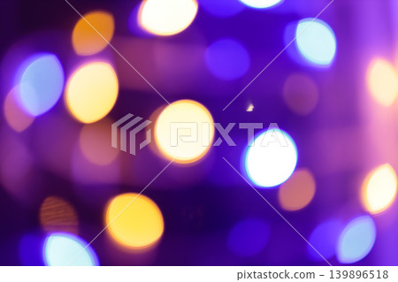 Abstract defocused bokeh lights with purple and warm yellow circles for a festive background Abstract defocused bokeh lights with purple and warm yellow circles for a festive background 139896518