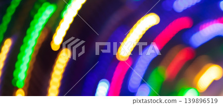 Abstract motion blur of colorful neon light trails with curved streaks for a festive night background Abstract motion blur of colorful neon light trails with curved streaks for a festive night background 139896519
