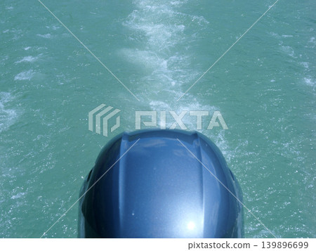 Outboard motor, waves, sunny day in April Outboard motor, waves, sunny day in April 139896699