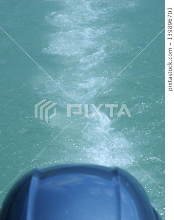 Outboard motor, waves, sunny day in April Outboard motor, waves, sunny day in April 139896701