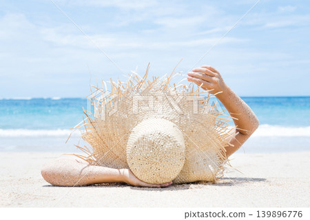 Woman lies on the white sand on the beach 139896776