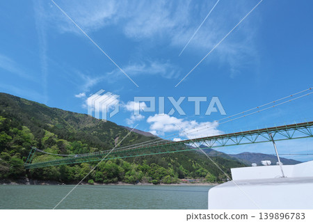 Igawa Dam, Igawa Lake, Oi River, sightseeing boat cruise, Igawa Bridge, sunny day in April Igawa Dam, Igawa Lake, Oi River, sightseeing boat cruise, Igawa Bridge, sunny day in April 139896783