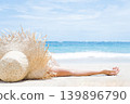 Woman lies on the white sand on the beach 139896790