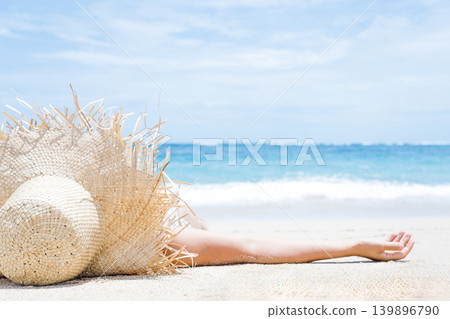 Woman lies on the white sand on the beach Woman lies on the white sand on the beach 139896790