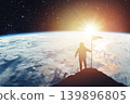 Silhouette of an astronaut with a flag against the backdrop of a planet and a shining star. Elements of this image furnished by NASA 139896805