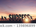 Silhouettes of people drawing the word SUCCESS on a sunset background, business concept 139896899