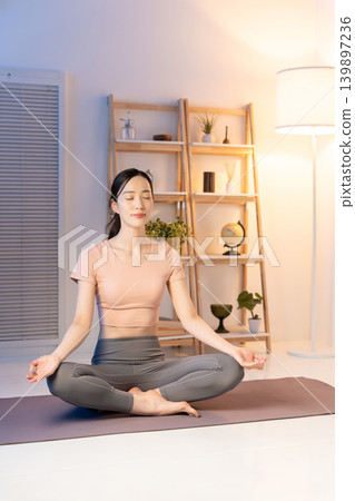 Women doing yoga at night Women doing yoga at night 139897236