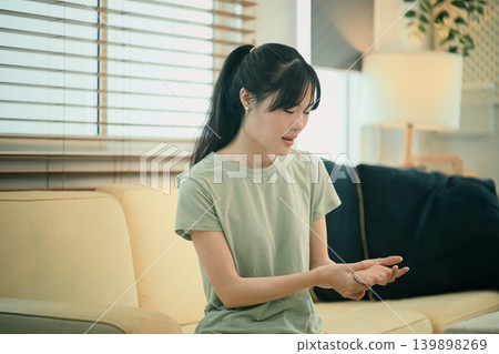 Young woman hand pain her injury pain from cramp, trigger finger, touching massaging, ache joint Young woman hand pain her injury pain from cramp, trigger finger, touching massaging, ache joint 139898269