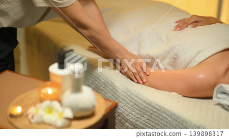 Closeup massage at spa with therapist in warm calm wellness room Closeup massage at spa with therapist in warm calm wellness room 139898317