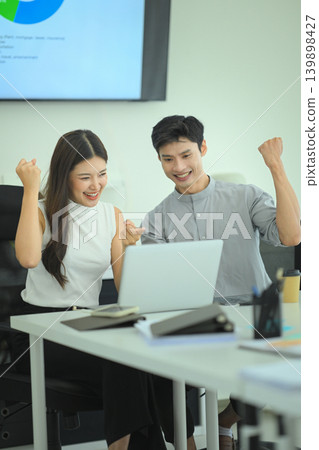 Business team celebrating successful results in office Business team celebrating successful results in office 139898427