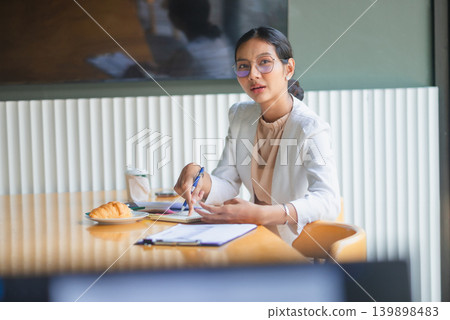 Businesswoman presenting a sales report on clipboard with pen in bright office, explaining chart data, marketing results, financial analysis, corporate strategy, teamwork, and modern meeting planning. Businesswoman presenting a sales report on clipboard with pen in bright office, explaining chart data, marketing results, financial analysis, corporate strategy, teamwork, and modern meeting planning. 139898483