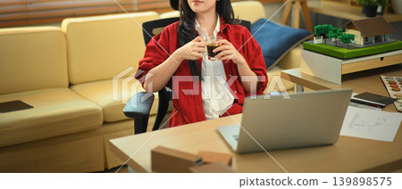 Cropped shot Architect relaxing with coffee after design work 139898575