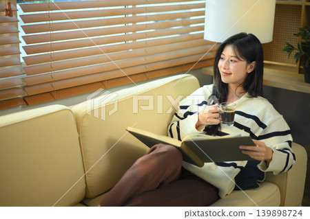 Woman reads a book, Quiet Afternoon Reading and Coffee break Woman reads a book, Quiet Afternoon Reading and Coffee break 139898724