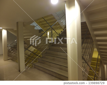 The dimly lit staircase in the commercial building The dimly lit staircase in the commercial building 139898729