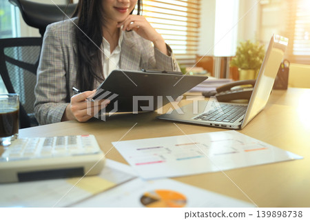 Checklist and clipboard task management, Businesswoman working with document and laptop, Audit finance data Checklist and clipboard task management, Businesswoman working with document and laptop, Audit finance data 139898738