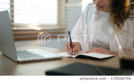 Closeup woman taking notes on table Closeup woman taking notes on table 139898746