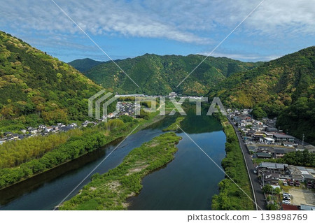 An aerial photograph overlooking a mountain village along the Nishiki River in Iwakuni City, Yamaguchi Prefecture. 139898769