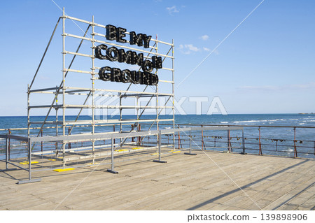 A large sign with illuminated letters that reads "BE MY COMMON GROUND" in Larnaka beach, Cyprus A large sign with illuminated letters that reads "BE MY COMMON GROUND" in Larnaka beach, Cyprus 139898906