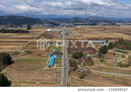 An aerial photograph showing a rural area and a straight road in Sakagawa Village, Yamagata Prefecture. 139899087