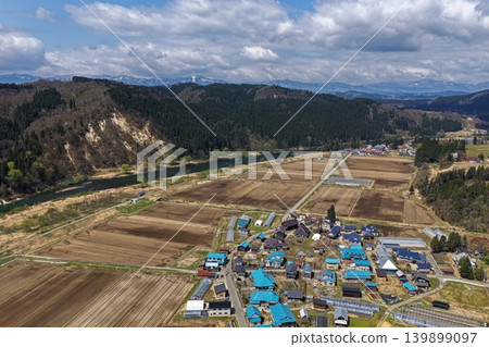 Aerial photograph capturing a rural settlement and cultivated land in Sakagawa Village, Yamagata Prefecture. Aerial photograph capturing a rural settlement and cultivated land in Sakagawa Village, Yamagata Prefecture. 139899097
