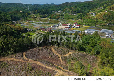 Aerial photograph overlooking a logging area and rural settlement in the foothills. Aerial photograph overlooking a logging area and rural settlement in the foothills. 139899229