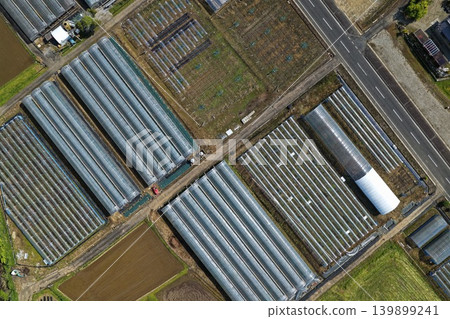 An aerial photograph showing a vast expanse of greenhouses in a rural area of Japan. An aerial photograph showing a vast expanse of greenhouses in a rural area of Japan. 139899241