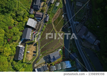 Aerial photograph showing a rural settlement, rice paddies, and roads in Takahashi City, Okayama Prefecture. Aerial photograph showing a rural settlement, rice paddies, and roads in Takahashi City, Okayama Prefecture. 139899398