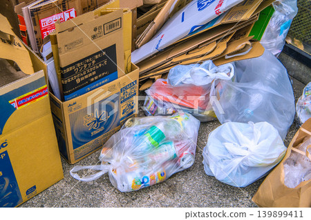 Illegal dumping in Yokohama, Japan: Bags containing empty cans and other waste discarded by an elderly man outside of collection days = Sunday, the 24th 139899411