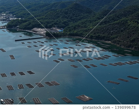 An aerial photograph overlooking oyster rafts in Mushimei Bay, Oku-cho, Setouchi City. An aerial photograph overlooking oyster rafts in Mushimei Bay, Oku-cho, Setouchi City. 139899678