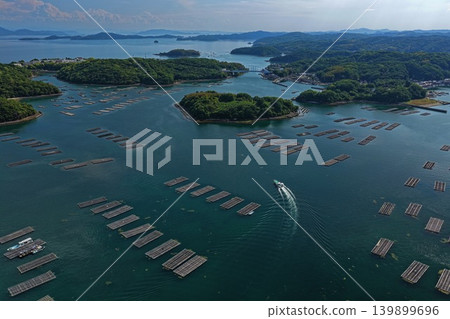 An aerial photograph overlooking oyster rafts and islands in Mushimyo, Oku-cho, Setouchi City, Okayama Prefecture. An aerial photograph overlooking oyster rafts and islands in Mushimyo, Oku-cho, Setouchi City, Okayama Prefecture. 139899696