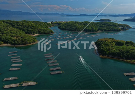 An aerial photograph overlooking oyster rafts and islands in Mushimyo, Oku-cho, Setouchi City, Okayama Prefecture. 139899701