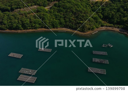 An aerial photograph overlooking oyster rafts in Mushimyo, Oku-cho, Setouchi City, Okayama Prefecture. An aerial photograph overlooking oyster rafts in Mushimyo, Oku-cho, Setouchi City, Okayama Prefecture. 139899708