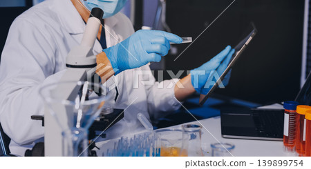 Lab technician experimenting in lab 139899754