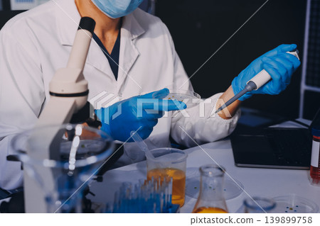 Lab technician experimenting in lab Lab technician experimenting in lab 139899758
