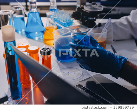 Lab technician experimenting in lab Lab technician experimenting in lab 139899759