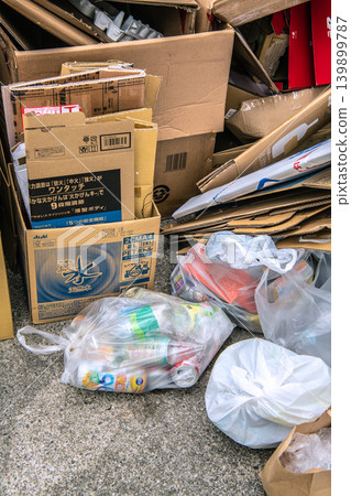 Illegal dumping in Yokohama, Japan: Bags containing empty cans and other waste discarded by an elderly man outside of collection days = Sunday, the 24th 139899787