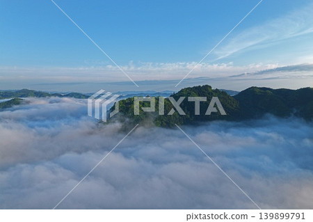 Aerial photograph capturing a sea of clouds near Matsuyama Castle in Takahashi City, Okayama Prefecture. Aerial photograph capturing a sea of clouds near Matsuyama Castle in Takahashi City, Okayama Prefecture. 139899791