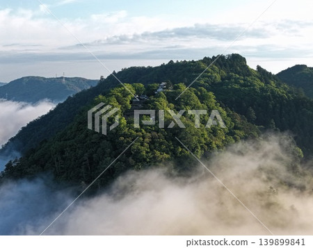 An aerial photograph capturing Bitchu Matsuyama Castle in Takahashi City, Okayama Prefecture, surrounded by a sea of clouds. An aerial photograph capturing Bitchu Matsuyama Castle in Takahashi City, Okayama Prefecture, surrounded by a sea of clouds. 139899841