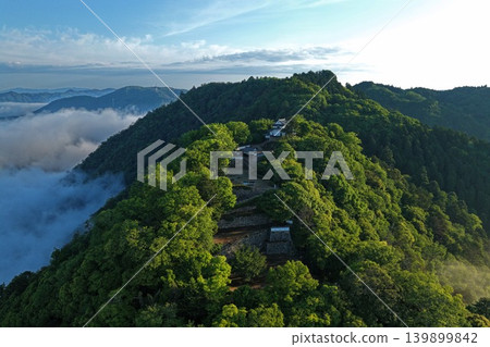 An aerial photograph capturing the ruins of Bitchu Matsuyama Castle in Takahashi City, Okayama Prefecture, along with a sea of clouds. An aerial photograph capturing the ruins of Bitchu Matsuyama Castle in Takahashi City, Okayama Prefecture, along with a sea of clouds. 139899842