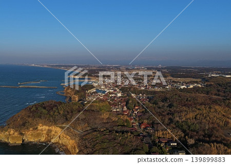An aerial photograph overlooking the coastline and fishing port of Kasa Cape in Kaga City, Ishikawa Prefecture. An aerial photograph overlooking the coastline and fishing port of Kasa Cape in Kaga City, Ishikawa Prefecture. 139899883