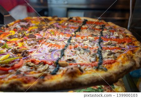 New york, usa august 19,2024. Fresh new yorkstyle pizza with melted cheese, crisp crust and toppings of red onion, peppers, mushrooms and savory meat 139900103