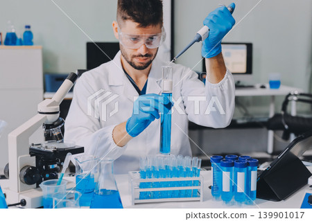 Lab technician experimenting in lab 139901017