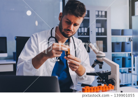 Attractive student of chemistry working in laboratory 139901055