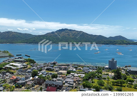 從空中俯瞰廣島縣初日市宮濱溫泉周圍的沿海居民點和水產養殖筏。 從空中俯瞰廣島縣初日市宮濱溫泉周圍的沿海居民點和水產養殖筏。 139901265