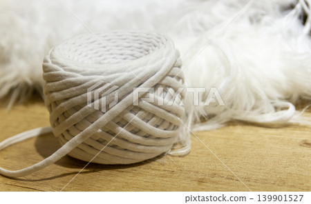 A spool of white cotton rope commonly used for crafts like macrame or as a candle wick A spool of white cotton rope commonly used for crafts like macrame or as a candle wick 139901527