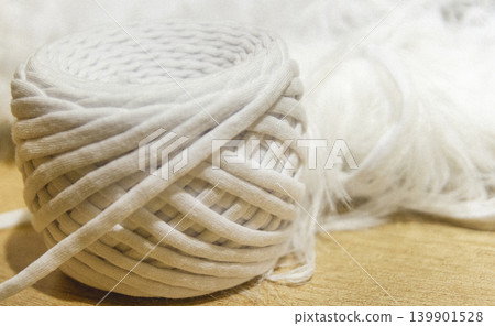 A spool of white cotton rope commonly used for crafts like macrame or as a candle wick A spool of white cotton rope commonly used for crafts like macrame or as a candle wick 139901528