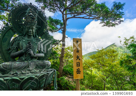 The sacred site of Shugendo, the Omine Okugake Trail: The statue of Dainichi Nyorai at the summit of Mt. Dainichi and the blue sky of early summer. *Location of photo is indicated in the comments section of the work. The sacred site of Shugendo, the Omine Okugake Trail: The statue of Dainichi Nyorai at the summit of Mt. Dainichi and the blue sky of early summer. *Location of photo is indicated in the comments section of the work. 139901693