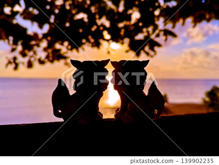 Okinawa: Shisa statues gazing at the setting sun Okinawa: Shisa statues gazing at the setting sun 139902235