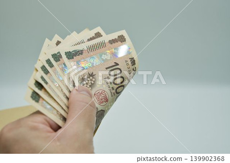 Male hand holding money Male hand holding money 139902368