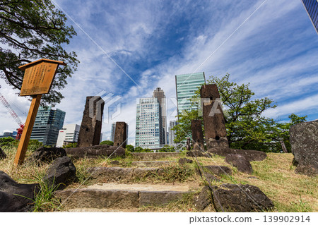 Historical stone pillars remaining in the former Shiba Rikyu Gardens, with buildings in the background. September 2023. Historical stone pillars remaining in the former Shiba Rikyu Gardens, with buildings in the background. September 2023. 139902914